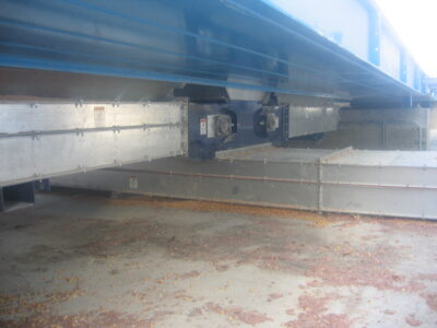 Transition from receiving conveyor into lower discharge conveyor. (Patented)