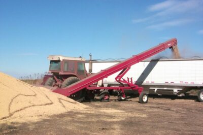 The 16 inch diameter by 10 foot long intake auger feeds an incline conveyor making quick work of grain pile clean up.