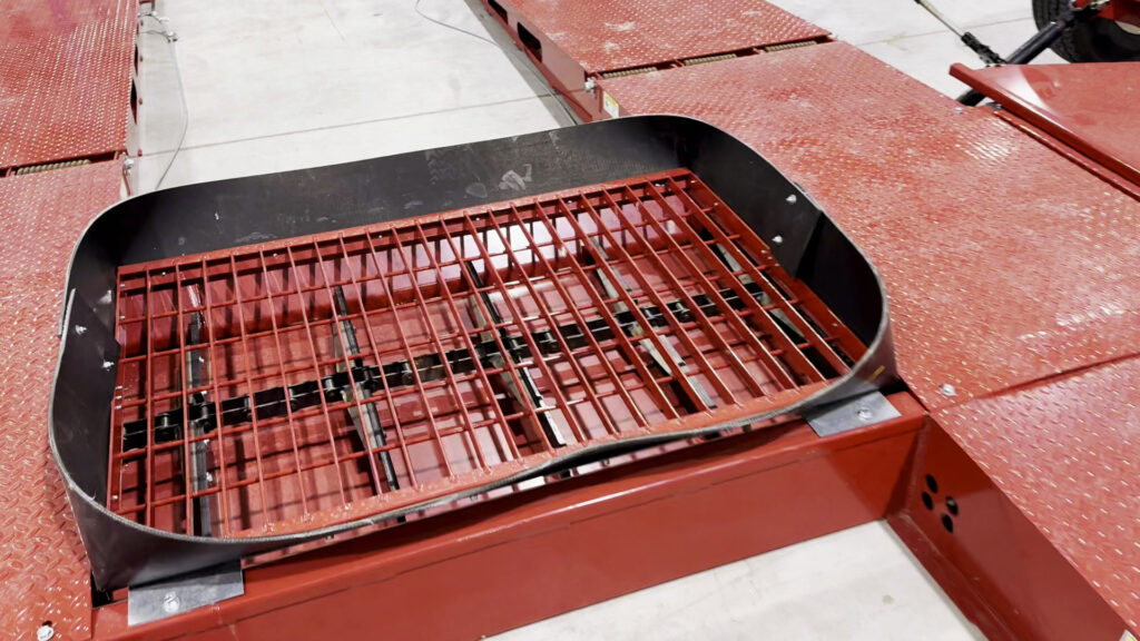 a close-up of the heavy-duty chain and poly paddles used on our low profile hopper