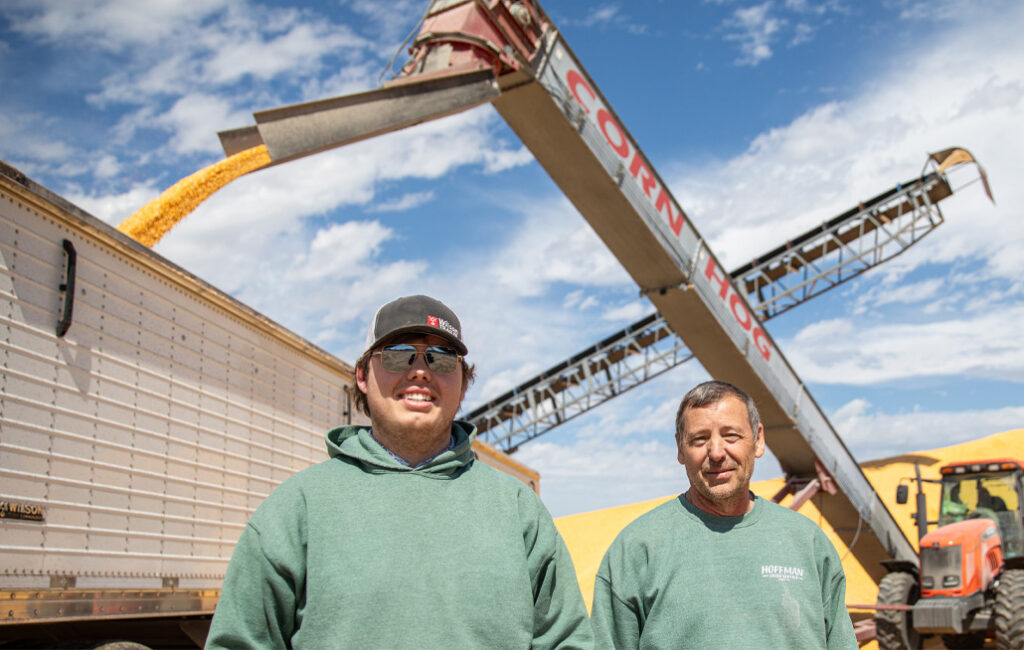 Jaxon and Rory Hoffman pose in front of Rory's Sudenga Ultra Scoop.