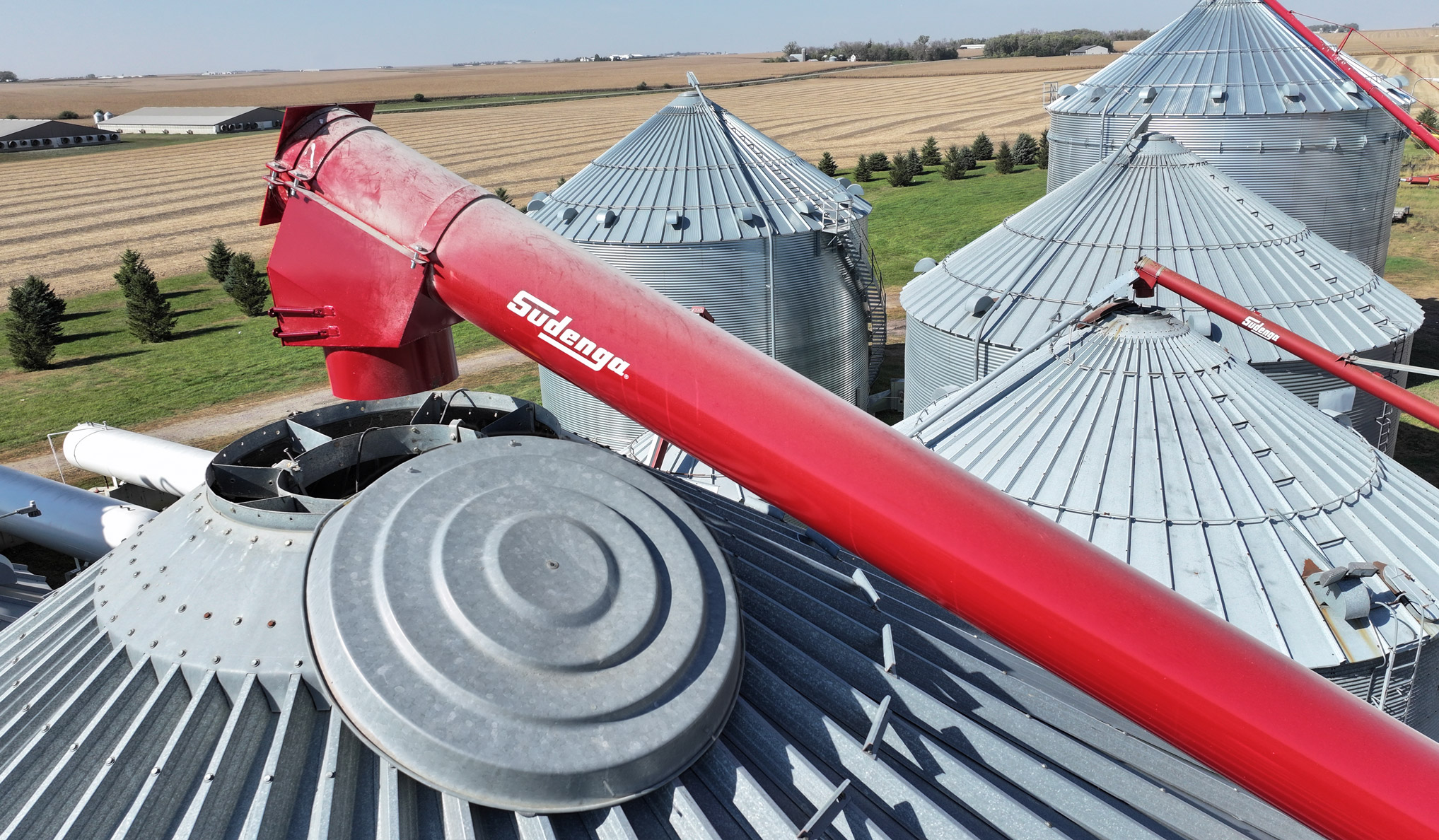 three Sudenga augers lined up to move grain into bins
